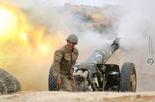 An ethnic Armenian soldier fires an artillery piece during fighting with Azerbaijan's forces in the breakaway region of Nagorno-Karabakh, in this handout picture released September 29, 2020. Defence Ministry of Armenia/Handout via REUTERS  ATTENTION EDITORS - THIS IMAGE HAS BEEN SUPPLIED BY A THIRD PARTY. NO RESALES. NO ARCHIVES. MANDATORY CREDIT. PICTURE WATERMARKED AT SOURCE.     TPX IMAGES OF THE DAY