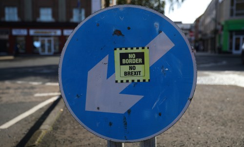 A 'No Border, No Brexit' sticker is seen below a road sign on the Irish side of the border between Ireland and Northern Ireland near Bridgend, Ireland October 16, 2019. Picture taken October 16, 2019. REUTERS/Phil Noble