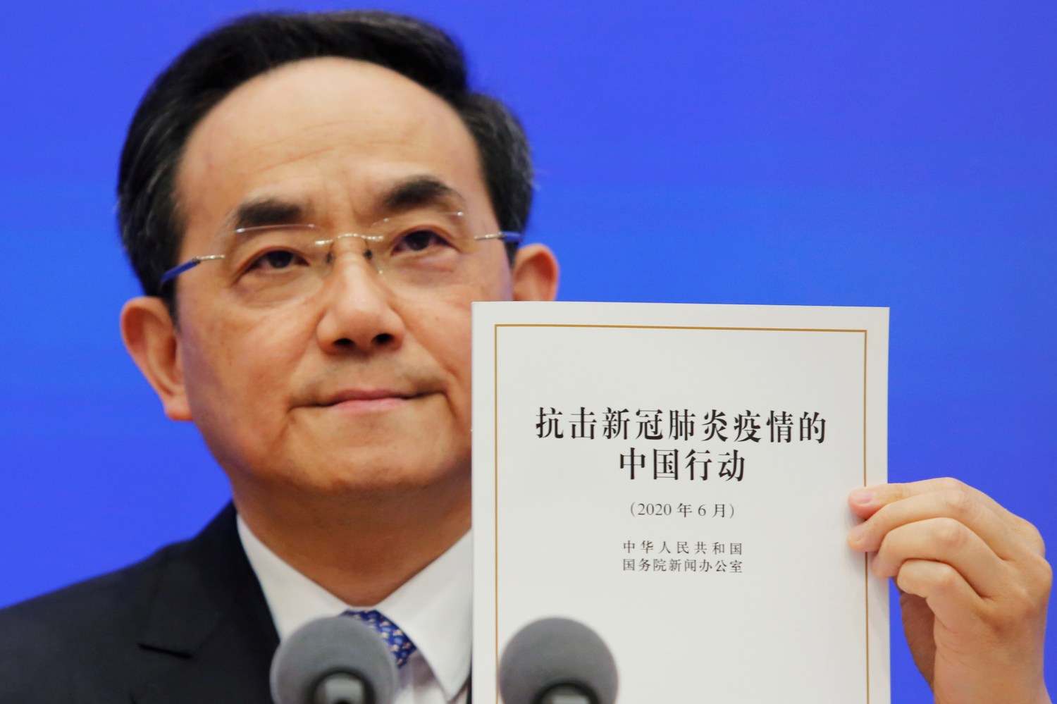 Xu Lin, vice head of the publicity department of the Communist Party of China (CPC) Central Committee, holds a copy of the white paper about China's fight against the coronavirus disease (COVID-19) during a State Council Information Office (SCIO) briefing in Beijing, China June 7, 2020.  REUTERS/Florence Lo