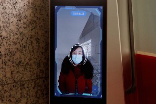 A woman has her face scanned by a facial recognition device that identifies people when they wear masks to gain access to the office of the Chinese electronics manufacturer Hanwang (Hanvon) Technology in Beijing as the country is hit by an outbreak of the novel coronavirus (COVID-19), China, March 6, 2020. Picture taken March 6, 2020.  REUTERS/Thomas Peter