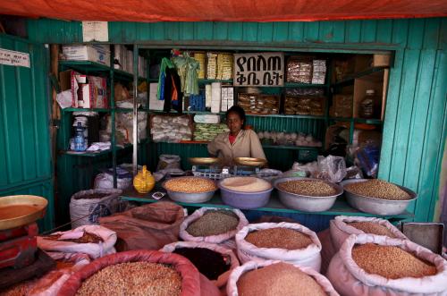 A shop owner poses for a photograph at the Mercato market in Addis Ababa December 16, 2015. Addis Ababa's 'Mercato' - Italian for 'market' - is reputedly the biggest open-air market in Africa, lying in the west of the capital. Supermarkets have sprouted across the city as the metropolis has expanded with Ethiopia's booming economy, but Mercato remains a popular destination for shoppers seeking clothing, electronics and a huge range of other items. It has been around for as long as the city, which was founded at the end of the 19th century, but it took its current form, and its name, from the Italians who invaded Ethiopia in 1935. The Italian occupation ended in 1941. Picture taken December 16, 2015.    REUTERS/Tiksa Negeri