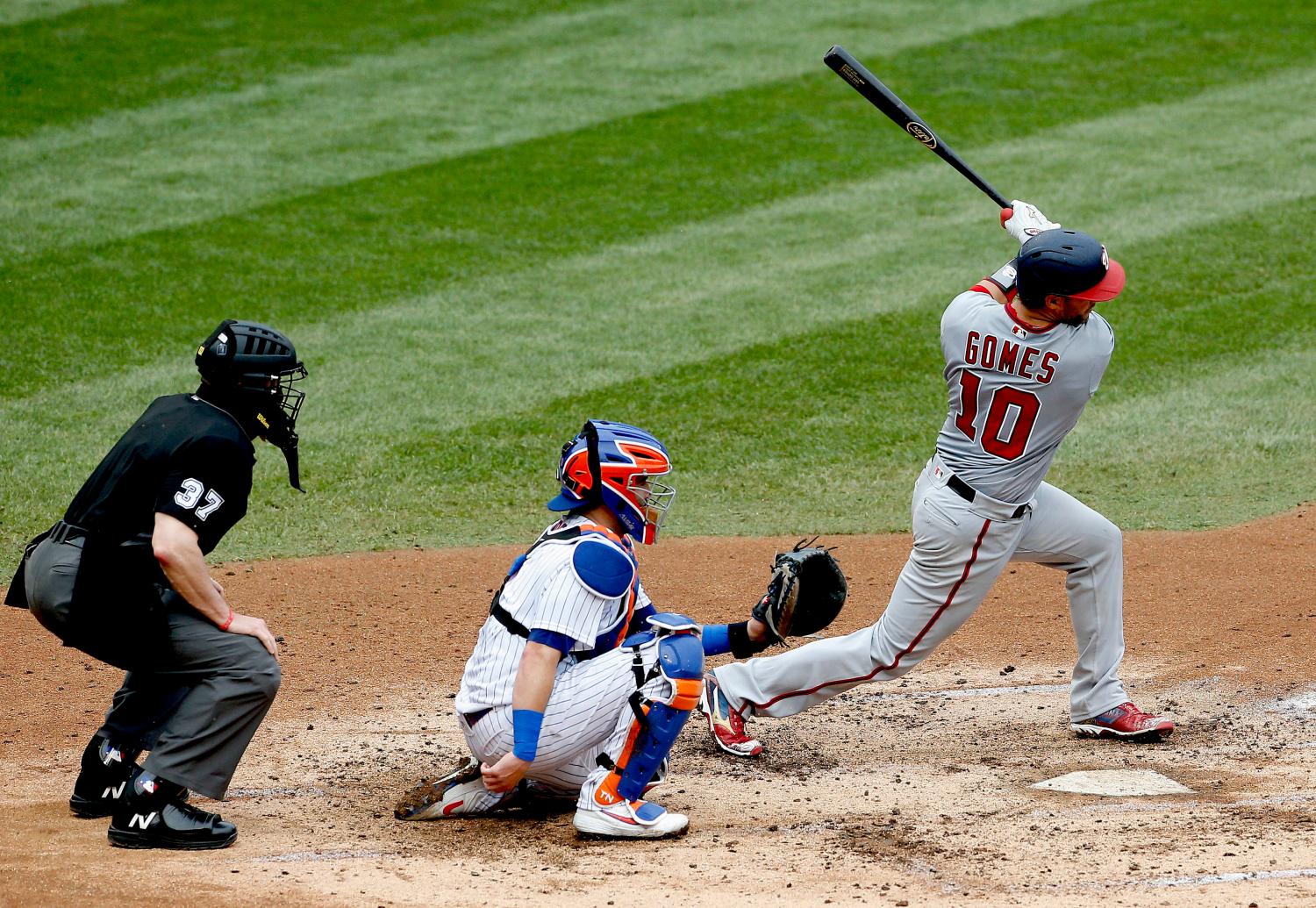 Aug 13, 2020; New York City, New York, USA; Washington Nationals catcher Yan Gomes (10) singles against the New York Mets during the fifth inning at Citi Field. Mandatory Credit: Andy Marlin-USA TODAY Sports