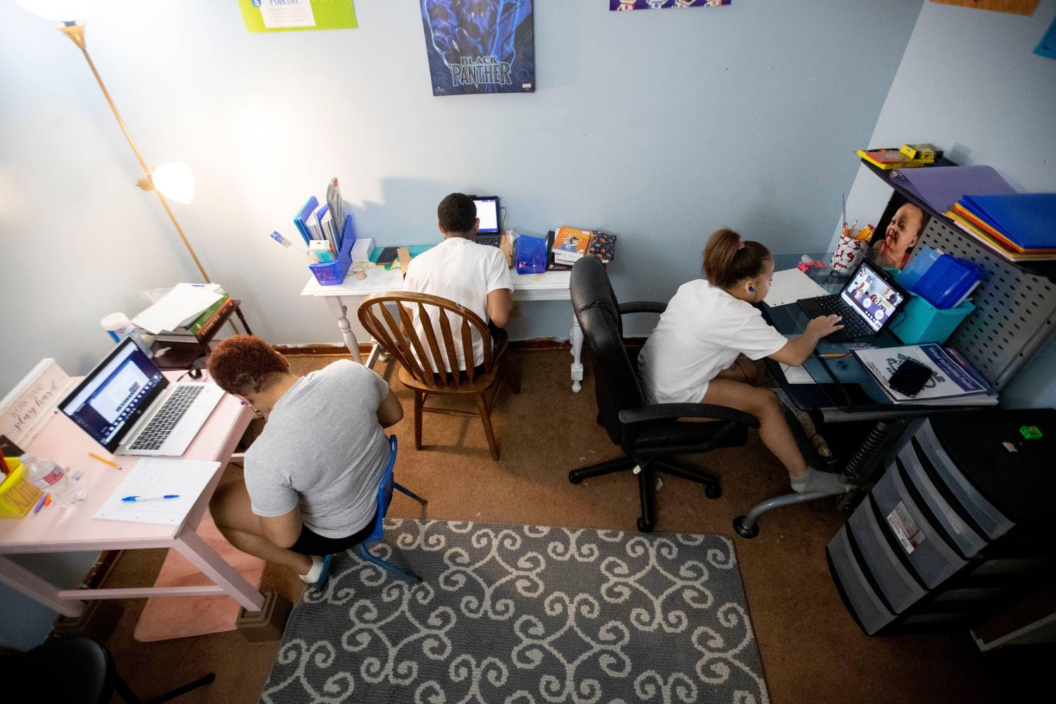 Khila Harris (from left), 15, Eric Harris, 12, and Kaylee Jones, 9, work on their laptops on the first day of school Monday, Aug. 31, 2020, from their home in Memphis.083120 Scsfirstday 13 Msg