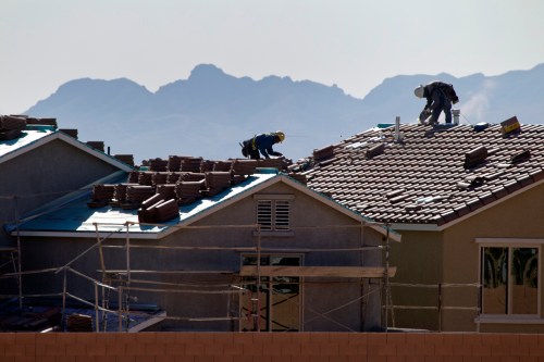 Roofers work on new homes at a residential construction site in the west side of the Las Vegas Valley in Las Vegas, Nevada April 5, 2013. The once-beleaguered Las Vegas housing market has been on fire since investment firms began buying homes here some eight months ago. Picture taken April 5, 2013. To match Special Report VEGAS-HOUSING/   REUTERS/Steve Marcus (UNITED STATES - Tags: REAL ESTATE BUSINESS CONSTRUCTION)