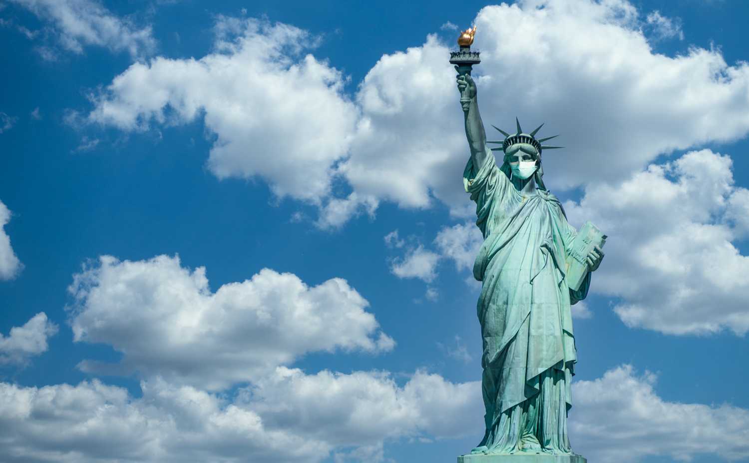 Statue of liberty wearing a surgical mask.