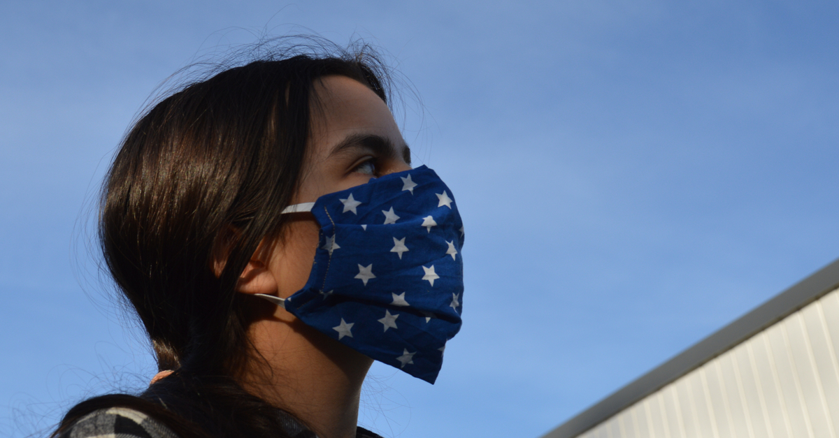 teenage girl wearing a mask