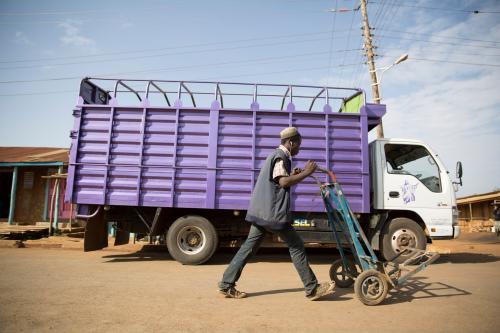 Eldoret,Uasin gishu/Kenya 25 January 2018: Unidentified man with a push cart walking next to a truck.
