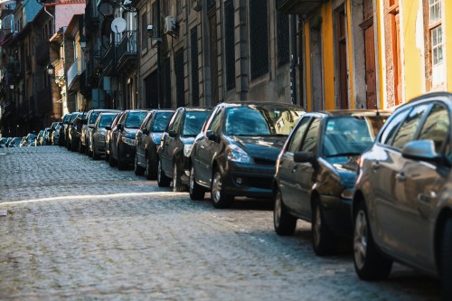 Cars parked along a cobblestone street