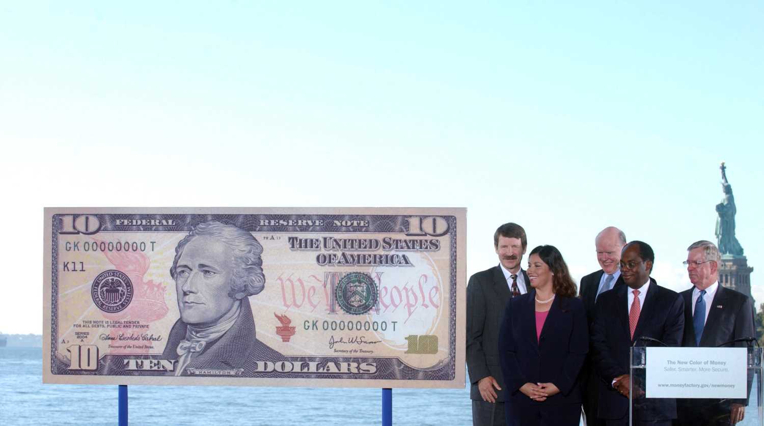 (L to R) Bureau of Engraving and Printing Director Thomas Ferguson, U.S. Treasurer Anna Escobedo Cabral, U.S. Secretary of the Treasury John Snow, Vice Chairman of the Board of Governors of the Federal Reserve Roger Ferguson, Jr., and U.S. Secret Service Director W. Ralph Basham unveil a sample ten dollar note at a ceremony on Ellis Island in New York September 28, 2005. The new bills are deigned with better security features to prevent counterfeiting. REUTERS/Keith Bedford