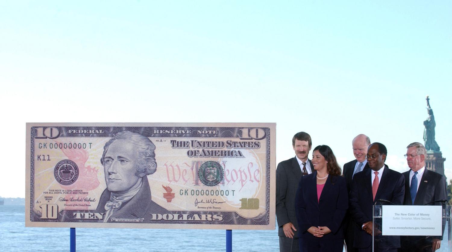 (L to R) Bureau of Engraving and Printing Director Thomas Ferguson, U.S. Treasurer Anna Escobedo Cabral, U.S. Secretary of the Treasury John Snow, Vice Chairman of the Board of Governors of the Federal Reserve Roger Ferguson, Jr., and U.S. Secret Service Director W. Ralph Basham unveil a sample ten dollar note at a ceremony on Ellis Island in New York September 28, 2005. The new bills are deigned with better security features to prevent counterfeiting. REUTERS/Keith Bedford