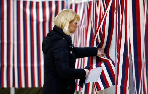 A voter enters the voting booth to mark her ballot with her vote in New Hampshire's first-in-the-nation U.S. presidential primary election in Allenstown, New Hampshire, U.S. February 11, 2020.  REUTERS/Jim Bourg