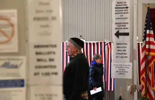 A voter (R) leaves a voting booth after casting her ballot in state's presidential primary election in Greenfield, New Hampshire, U.S. February 11, 2020.    REUTERS/Gretchen Ertl