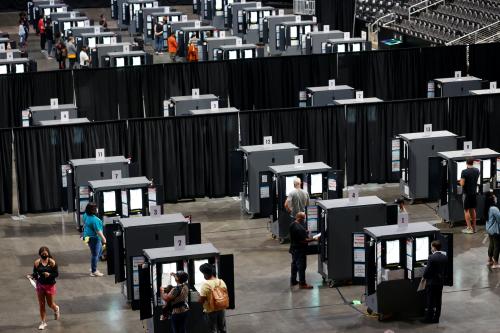 People cast their ballots during early voting for the upcoming presidential elections inside of The Atlanta Hawks' State Farm Arena in Atlanta, Georgia, U.S., October 12, 2020.  REUTERS/Chris Aluka Berry