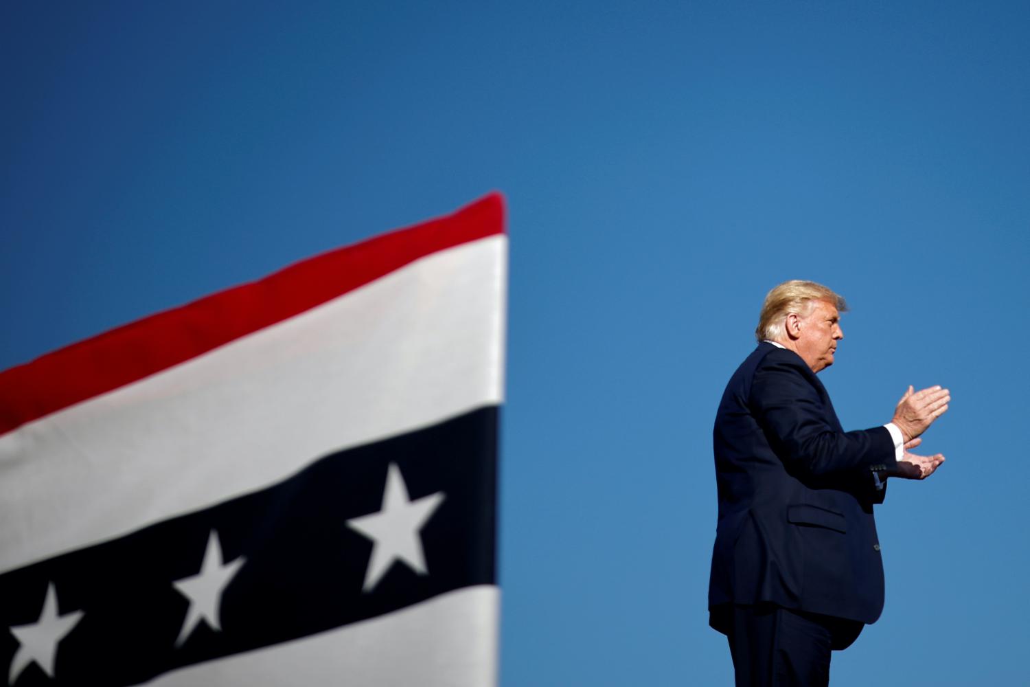 FILE PHOTO: FILE PHOTO: U.S. President Donald Trump claps during a campaign rally in Carson City, Nevada, U.S., October 18, 2020. REUTERS/Carlos Barria/File Photo/File Photo