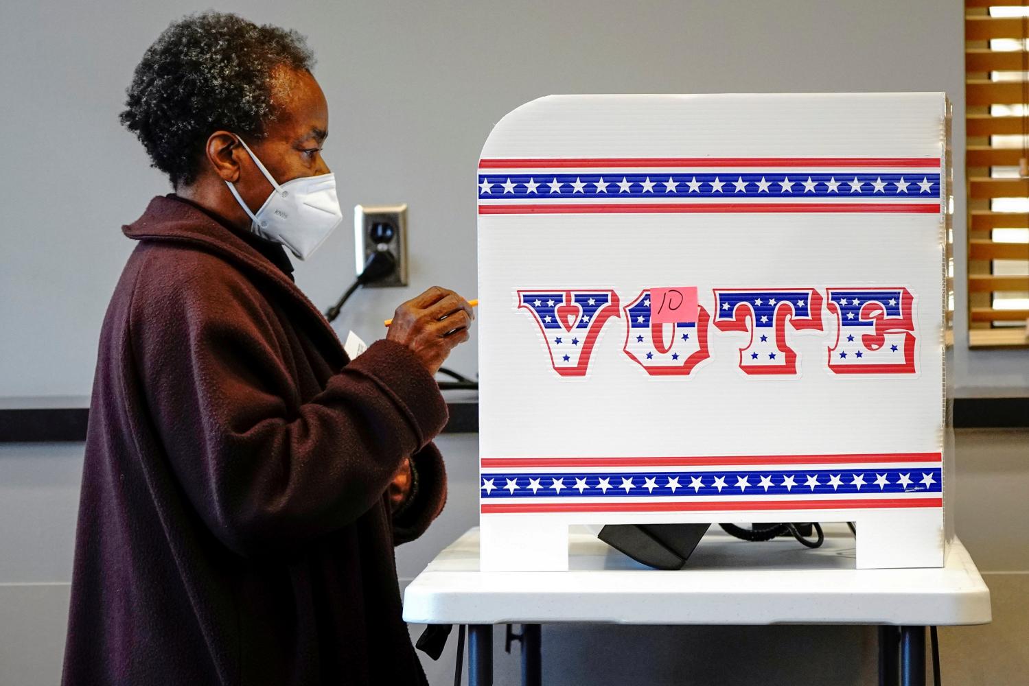 FILE PHOTO: Ruby Lenora casts her in-person vote on her 73rd birthday at a polling site at the Milwaukee Public Library?s Washington Park location in Milwaukee, on the first day of in-person voting in Wisconsin, U.S., October 20, 2020. Wisconsin?s early voting period, known as absentee in-person voting, began October 20.  REUTERS/Bing Guan/File Photo