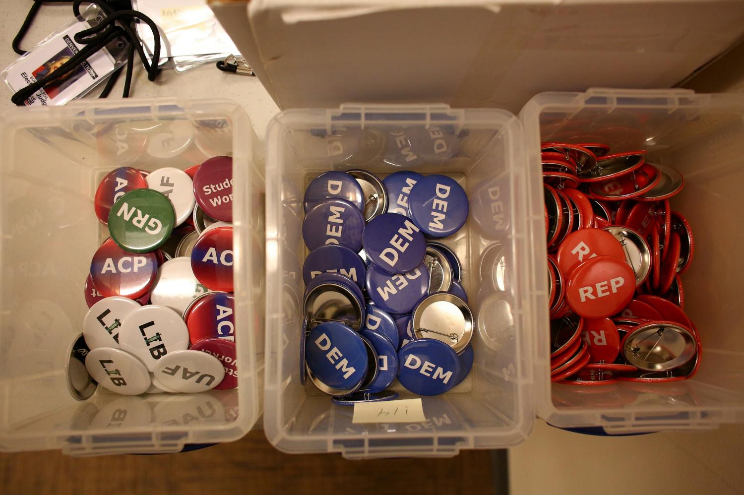 Election officials in Denver are required to wear buttons indicating their party officiation or if they are unaffiliated while processing and counting ballots for the upcoming presidential election in Colorado, U.S., October 22, 2020.  REUTERS/Kevin Mohatt