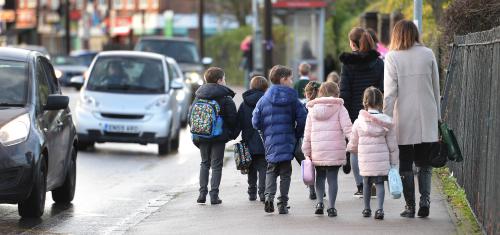 Parents walk their children to school in Hornchurch, Essex, past stationary vehicles near to the school grounds. PA Photo. Picture date: Friday January 17, 2020. Photo credit should read: Nick Ansell/PA Wire