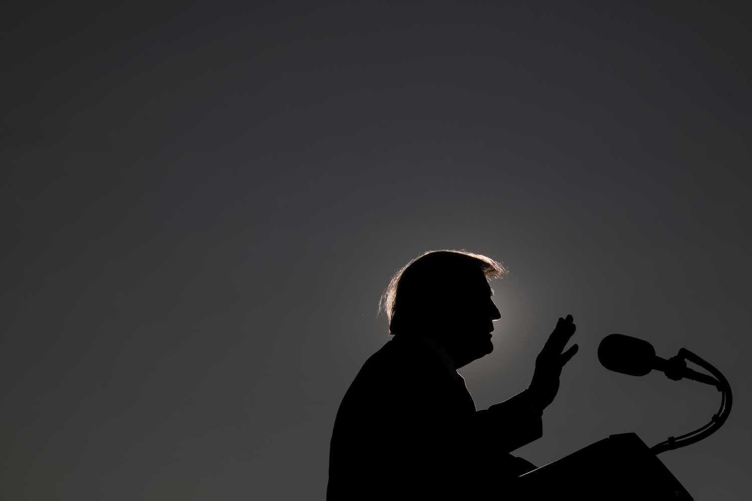 U.S. President Donald Trump is silhouetted as he delivers a speech while campaigning at Dayton International Airport in Dayton, Ohio, U.S., September 21, 2020. REUTERS/Tom Brenner
