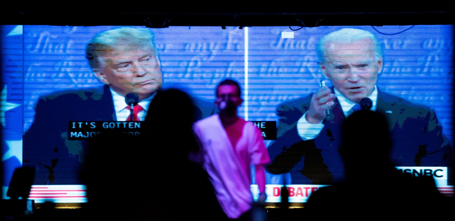 People watch the second 2020 presidential campaign debate between Democratic presidential nominee Joe Biden and U.S. President Donald Trump at The Abbey Bar during the outbreak of the coronavirus disease (COVID-19), in West Hollywood, California, U.S., October 22, 2020. REUTERS/Mario Anzuoni