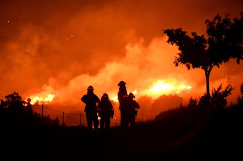 FILE PHOTO: Los Angeles County firefighters keep watch on the Bobcat Fire as it burns through the night in Juniper Hills, California, U.S. September 19, 2020.  REUTERS/Gene Blevins/File Photo
