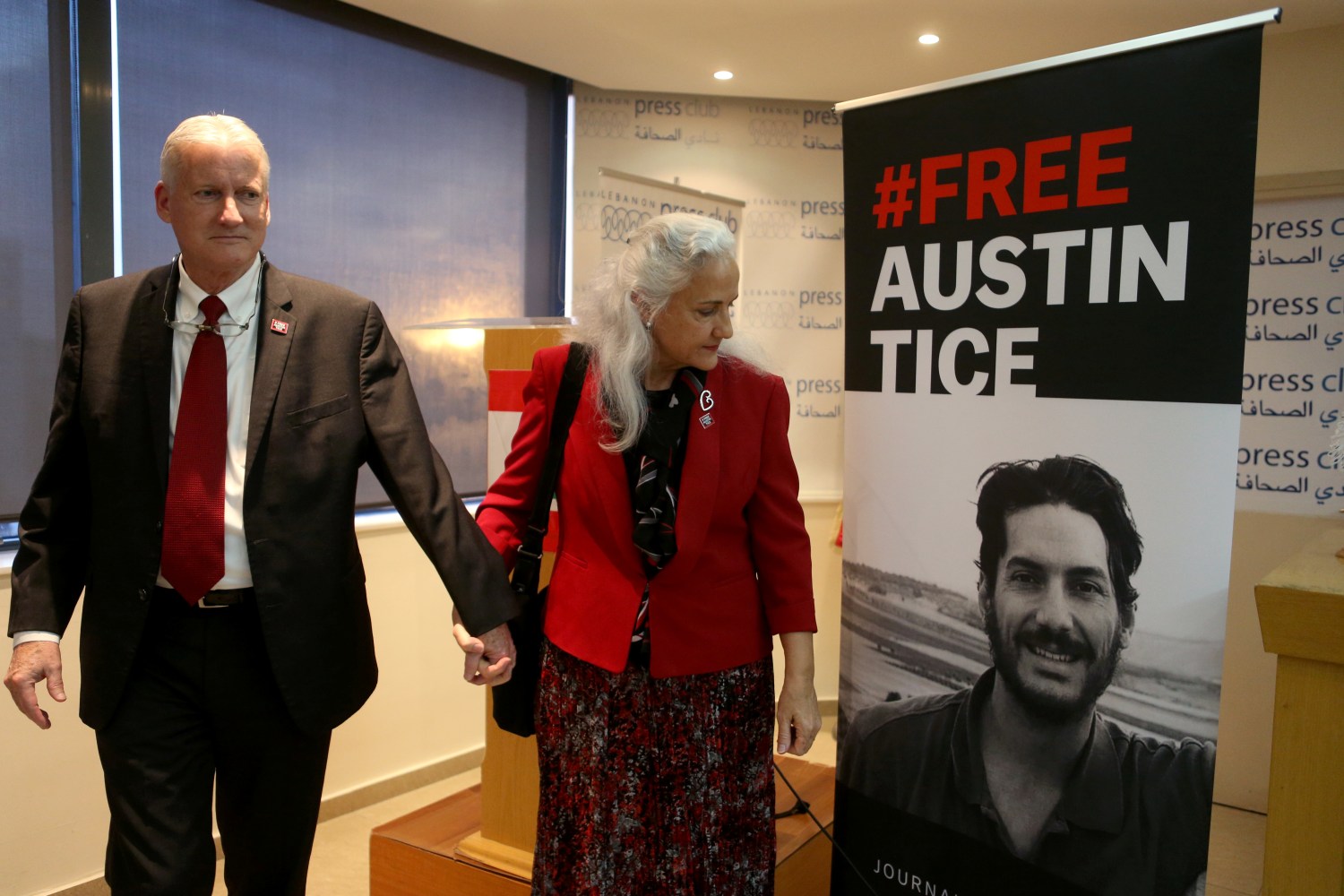 Marc and Debra Tice, parents of U.S. journalist Austin Tice, walk past a poster of their son after the news conference in Beirut, Lebanon December 4, 2018. REUTERS/Mohamed Azakir