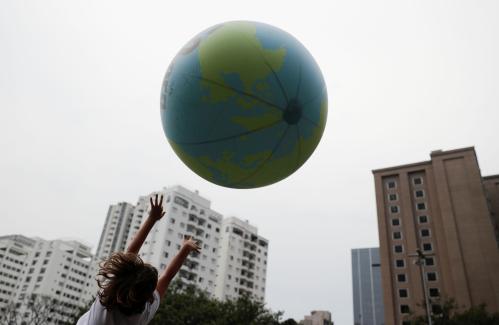A child plays with a ball that represents an earth globe during the Global Climate Strike of the Fridays for Future movement in Sao Paulo, Brazil September 20, 2019. REUTERS/Nacho Doce  