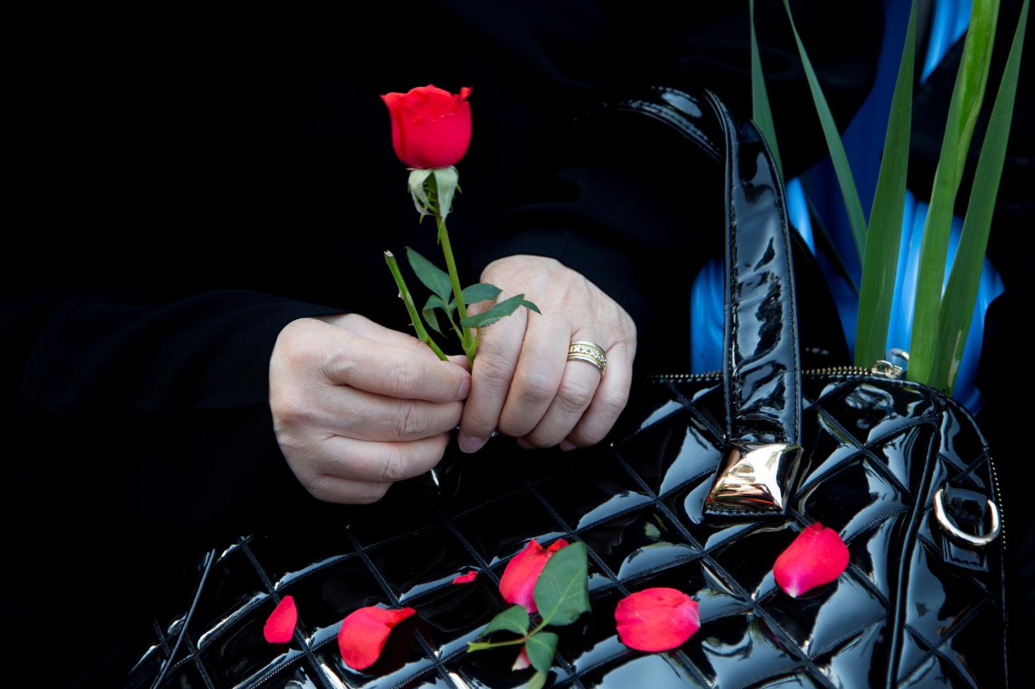 REFILE - CORRECTING TYPO  An Iranian woman holds a red flower as she attends a ceremony to bury remains of 150 "martyrs" from 1980-88 Iran-Iraq war in Tehran, Iran June 27, 2019. Nazanin Tabatabaee/West Asia News Agency via REUTERS. ATTENTION EDITORS - THIS PICTURE WAS PROVIDED BY A THIRD PARTY