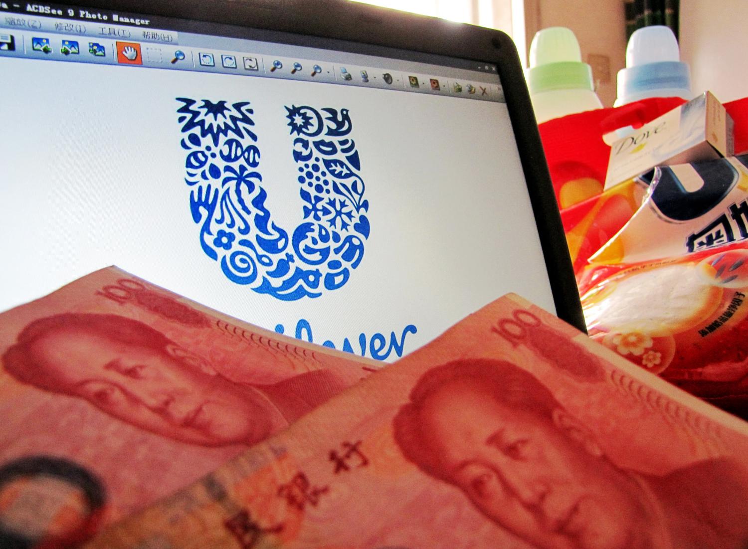 --FILE--A Unilever logo is seen on a computer screen as well as hundred Renminbi note in Shanghai, China, 06 May 2011. The Chinese government is getting tough in its fight to tame inflation, fining a foreign company more than $300,000 just for talking about its plans to raise prices.The Anglo-Dutch company Unilever spokesman announced in March that rising costs of materials might lead the firm to increase the prices of its toiletries and other products by as much as 15 percent, which sparked a run on Unilever products and hoarding that disrupted market prices.Unilever, which recently said it hoped to boost its sales of $2 billion a year in China fivefold by 2020, accepted its costly punishment. No Use China. No Use France.