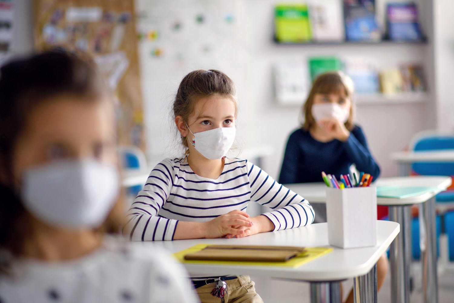 children in classroom wearing masks