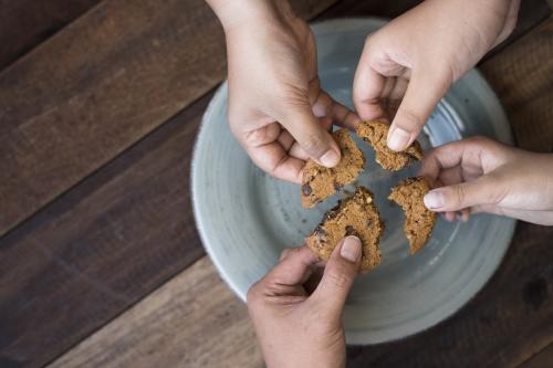 People splitting a cookie