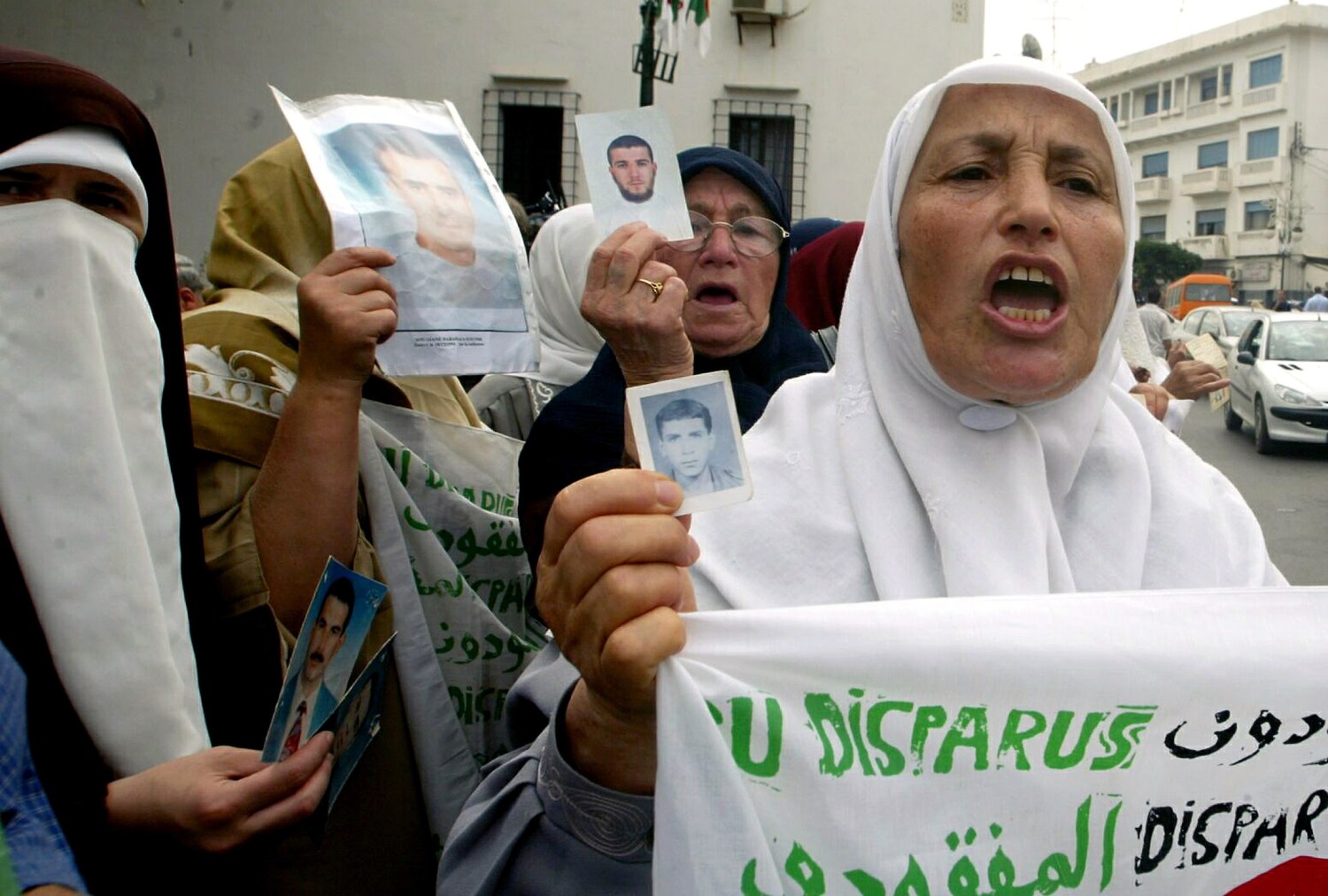 Algerian mothers hold up photographs of their disappeared loved ones during a protest outside the office of a human rights group in Algiers September 28, 2005. For a decade, dozens of mothers have held sit-ins once a week outside the office demanding the return of their loved ones or information about their fates. Algeria's national referendum, which will be held on September 29 aims at ending more than a decade of conflict which will help Islamists reach their goal of forming a purist Islamic republic ,an influential former leading militant said on Monday. REUTERS/Louafi Larbi