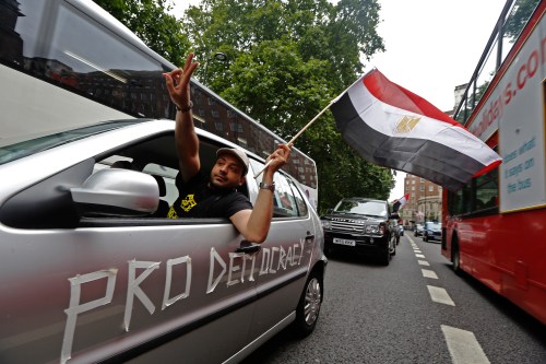 Supporters of deposed President Mohamed Mursi demonstrate as they slow drive through central London August 17, 2013. Supporters of Mursi fought a gunbattle with security forces in a Cairo mosque on Saturday, while Egypt's army-backed government, facing deepening chaos, considered banning his Muslim Brotherhood group.  REUTERS/Luke MacGregor (BRITAIN - Tags: CIVIL UNREST POLITICS RELIGION)