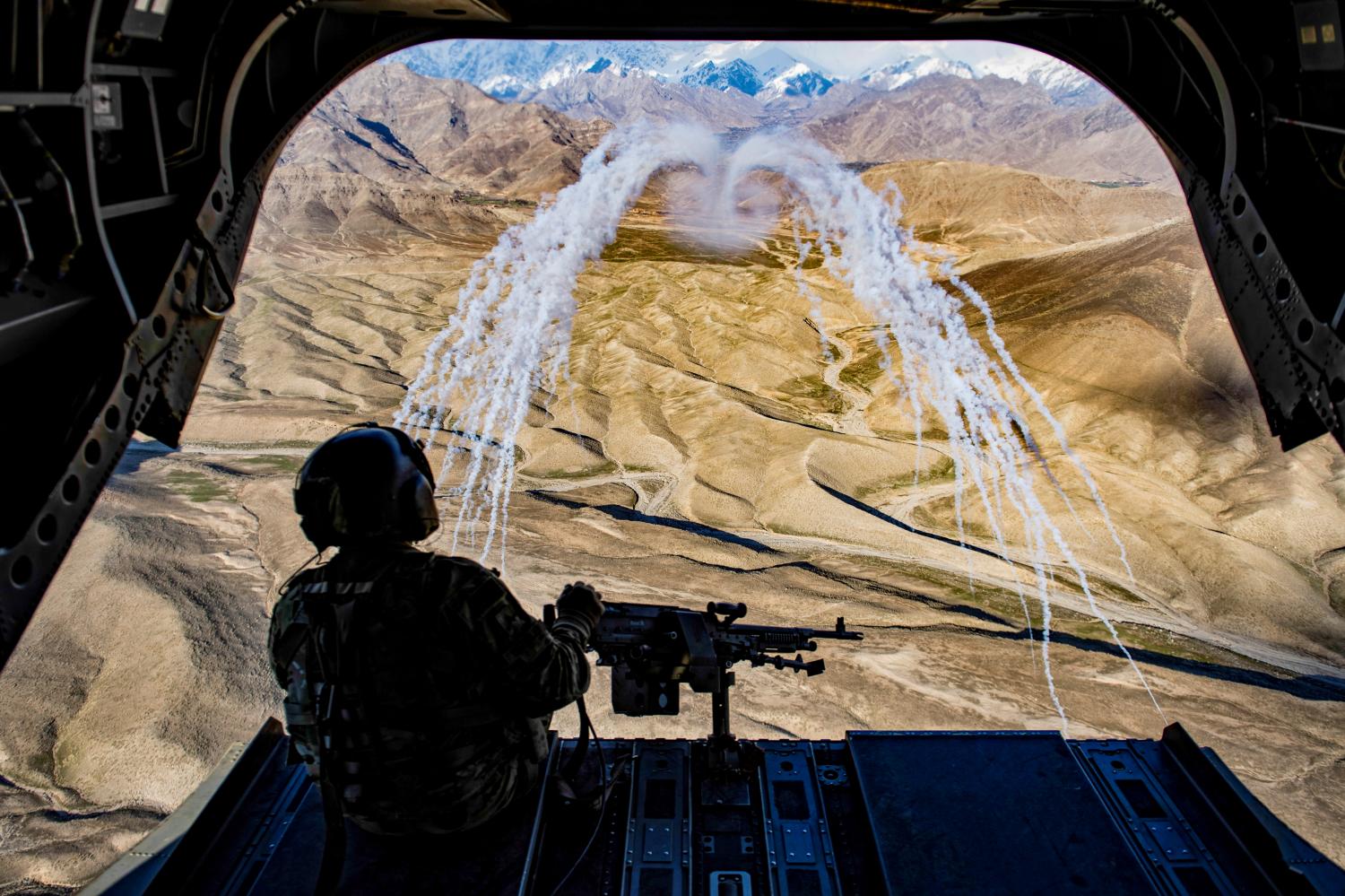 A U.S. Army crew chief flying on board a CH-47F Chinook helicopter observes the successful test of flares during a training flight in Afghanistan, March 14, 2018. Picture taken March 14, 2018.  U.S. Air Force/Tech. Sgt. Gregory Brook/Handout via REUTERS.    ATTENTION EDITORS - THIS IMAGE WAS PROVIDED BY A THIRD PARTY      TPX IMAGES OF THE DAY