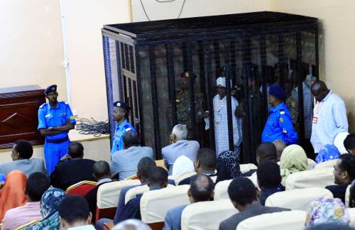 Sudan's former president Omar Hassan al-Bashir stands guarded inside a cage at the courthouse where he is facing corruption charges, in Khartoum, Sudan August 19, 2019. REUTERS/Mohamed Nureldin Abdallah