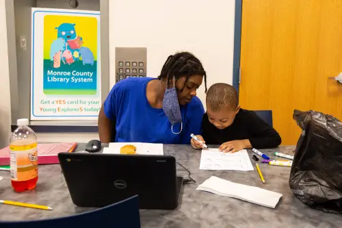 Trachelle Bivins and her 5-year-old son, Ondrae Florence, complete his school work together at the Central Library of Rochester on Tuesday, Sept. 29, 2020. Ondrae would have attended school at School 23, part of the Rochester City School District, if the district had not moved to online learning. Ondrae and his mom have internet at home, but choose to come to the library because it creates a better learning environment for him.urban internet