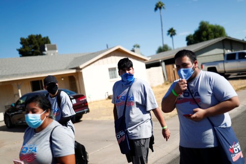 Members of Mi Familia Vota walk along a street to promote the importance of the Latino vote in the majority Hispanic neighbourhood of Maryvale in Phoenix, Arizona U.S., November 1, 2020. REUTERS/Edgard Garrido