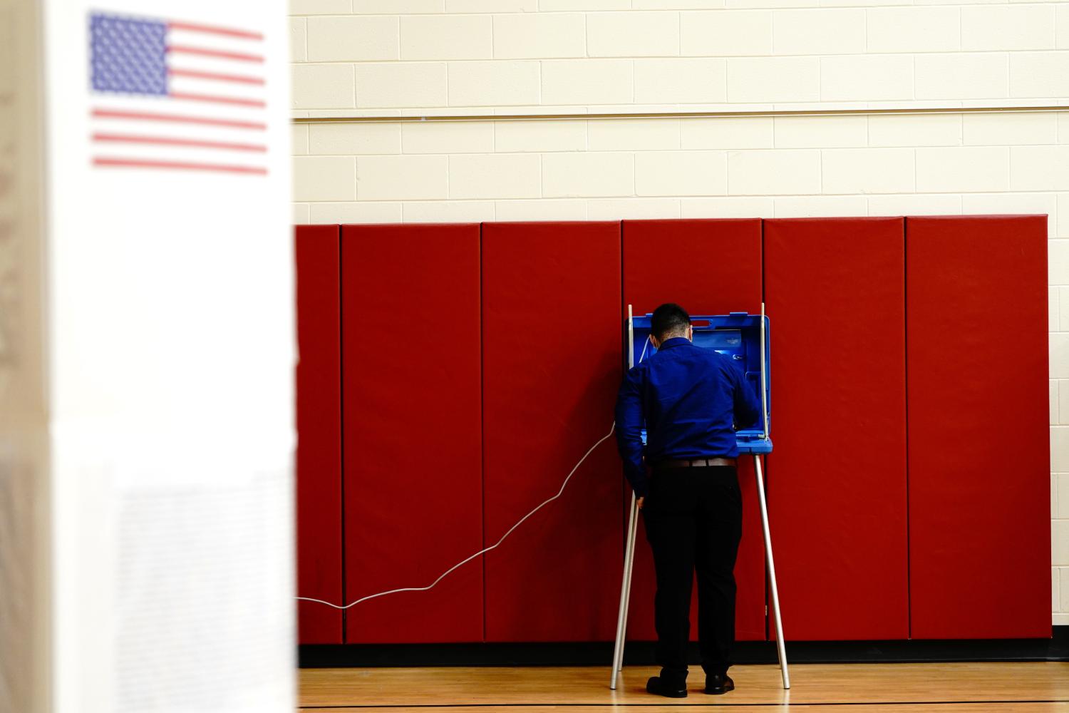 A voter completes his ballot inside a privacy booth at a polling station inside Knapp Elementary School on Election Day in Racine, Racine County, Wisconsin, U.S. November 3, 2020. REUTERS/Bing Guan