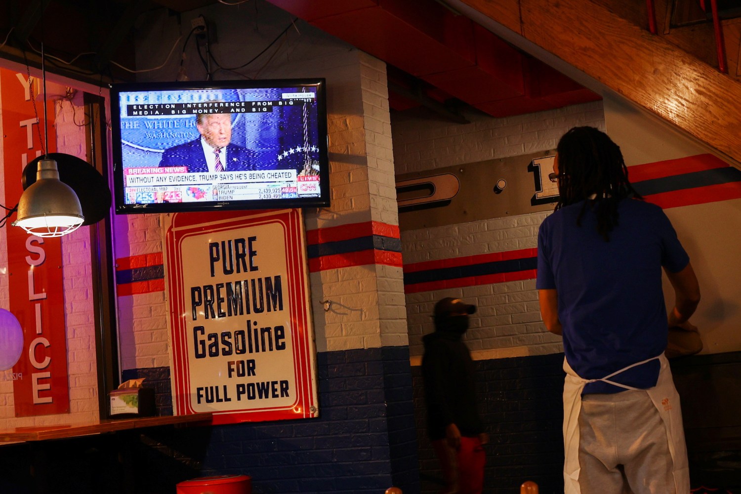 A TV screen at a restaurant shows U.S. President Donald Trump speaking after Election Day in Washington, D.C., U.S., November 5, 2020. REUTERS/Hannah McKay