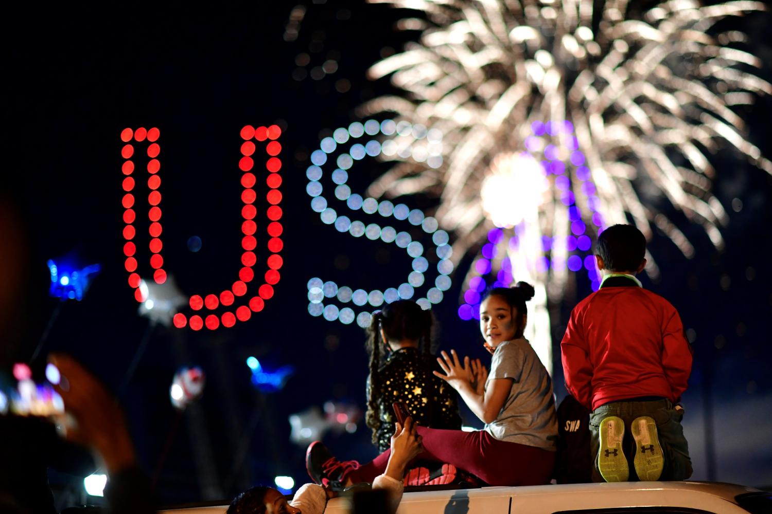 People watch fireworks after media announced that Democratic U.S. presidential nominee Joe Biden has won the 2020 U.S. presidential election, in Wilmington, Delaware, U.S. November 7, 2020. REUTERS/Mark Makela