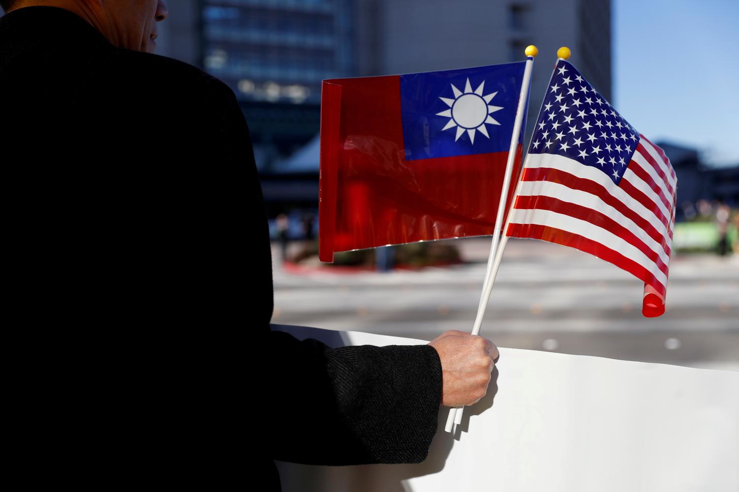 FILE PHOTO: A man holds flags of Taiwan and the United States in support of Taiwanese President Tsai Ing-wen during an stop-over after her visit to Latin America in Burlingame, California, U.S., January 14, 2017. REUTERS/Stephen Lam/File Photo