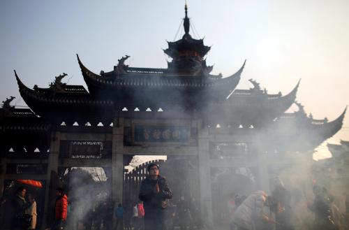 A man prays on the second day of the Chinese Lunar New Year at Longhua Buddhist Temple in Shanghai February 4, 2011. The Lunar New Year began on February 3 and marks the start of the Year of the Rabbit, according to the Chinese zodiac. REUTERS/Carlos Barria  (CHINA - Tags: SOCIETY RELIGION ANNIVERSARY)