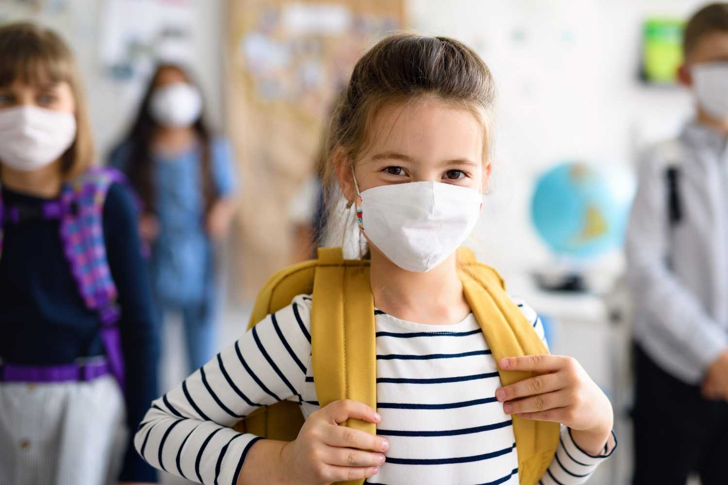 Female student wears a mask in school
