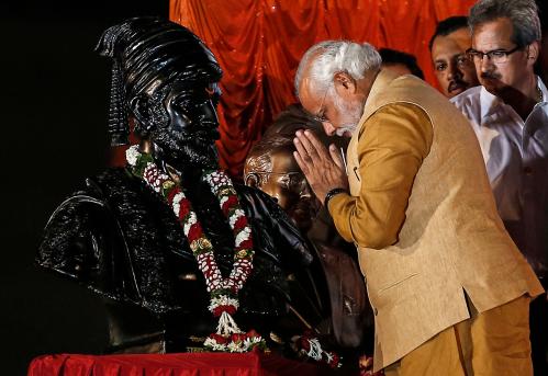 Hindu nationalist Narendra Modi, prime ministerial candidate for the main opposition Bharatiya Janata Party (BJP), gestures at the statue of Chhatrapati Shivaji, revered by many in western India as a Hindu warrior king, during an election campaign rally in Mumbai April 21, 2014. Around 815 million people have registered to vote in the world's biggest election - a number exceeding the population of Europe and a world record - and results of the mammoth exercise, which concludes on May 12, are due on May 16. REUTERS/Danish Siddiqui (INDIA - Tags: ELECTIONS POLITICS)