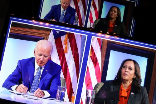 U.S. president elect Joe Biden and Vice president-elect Kamala Harris appear on video screens as they hold a virtual meeting with their coronavirus disease (COVID-19) advisory council in Wilmington, Delaware, U.S. November 9, 2020.  REUTERS/Jonathan Ernst? - RC2SZJ90NP2W