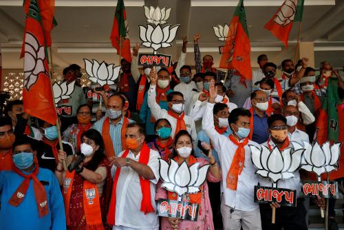 Supporters of India's ruling Bharatiya Janata Party (BJP) hold their party symbols and flags as they gather to celebrate after learning of the initial poll results of the Bihar state assembly election and by-elections in Gujarat, Karnataka and Madhya Pradesh states, in Gandhinagar, India, November 10, 2020. REUTERS/Amit Dave - RC2C0K98BBEN
