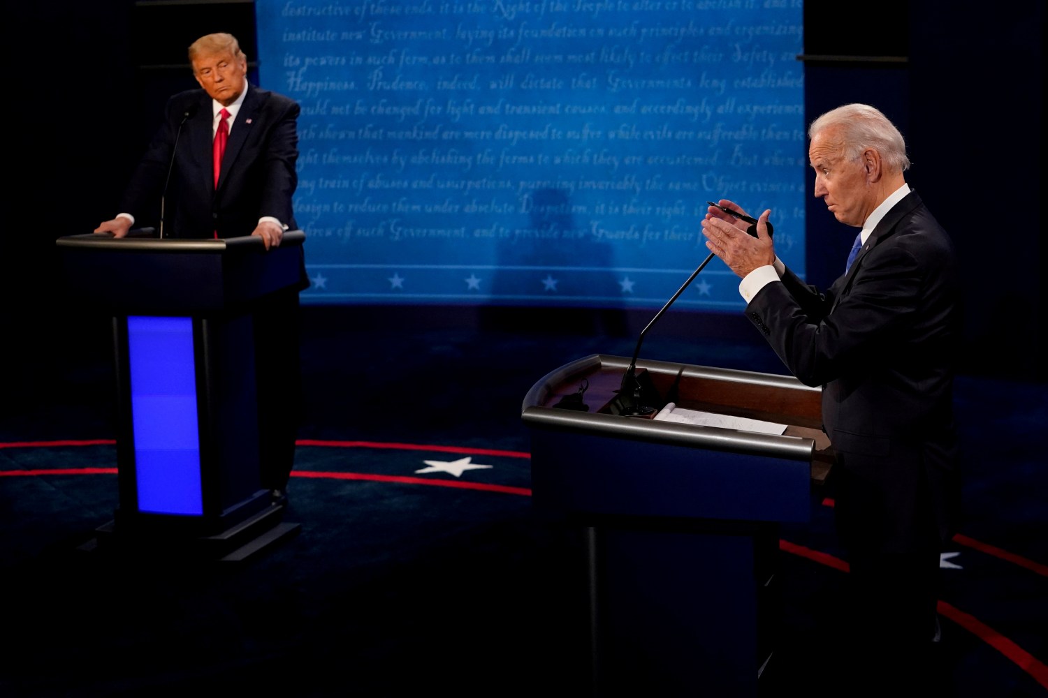 FILE PHOTO: Democratic presidential candidate former Vice President Joe Biden answers a question as President Donald Trump listens during the second and final presidential debate at the Curb Event Center at Belmont University in Nashville, Tennessee, U.S., October 22, 2020. Morry Gash/Pool via REUTERS/File Photo
