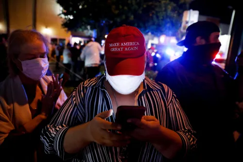 FILE PHOTO: A supporter of U.S. President Donald Trump wears a 'Make America Great Again' cap during the 2020 U.S. presidential election, in Miami, Florida, U.S., November 4, 2020. REUTERS/Marco Bello/File Photo
