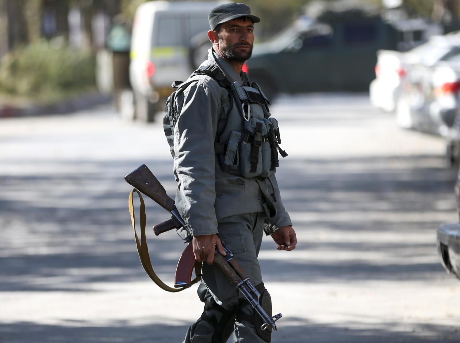 An Afghan policeman keeps watch near the site of an attack at the university of Kabul, Afghanistan November 2, 2020. REUTERS/Omar Sobhani