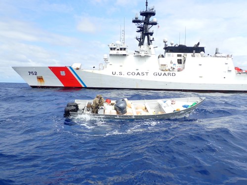 *VIDEO AVAILABLE: info@covermg.com*THIS PICTURE SHOWS: In one of the busts of the boat's recent tour, the Coast Guard Cutter Stratton (WMSL 752) boarding team searches a suspected smuggling vessel interdicted in international waters of the Eastern Pacific Ocean, May 31, 2020. The team seized more than 1,500 pounds of cocaine from the suspected smuggling vessel.....STORY COPY:This is the incredible moment the U.S. Coast Guard took out a drug smuggling boat’s engine with a bullet. Footage shows warning shots strafing across the water in front of the fast-moving boat in the Eastern Pacific Ocean, before a marksman disabled the vessel’s engine. It is thought that the warning shots from the helicopter would have been fired with a mounted M240 machine gun, while the disabling round would have come from a precision rifle. The scenes are among highlights of the Coast Guard Cutter Stratton patrol boat as it returned to Coast Guard Island on 29 June after a 94-day counter-drug patrol in the Eastern Pacific Ocean. During the tour, The crew detected and interdicted five suspected drug smuggling vessels, detained 14 suspected drug smugglers and seized over 6,000 pounds of cocaine worth an estimated $113 million. The Stratton's advanced capabilities include a small unmanned aircraft system, an attached Helicopter Interdiction Tactical Squadron MH-65 helicopter and aircrew, and an embarked Law Enforcement Detachment from the Pacific Tactical Law Enforcement Team. On June 27, Stratton's crew offloaded 3,720 pounds of marijuana seized in known drug-transit zones in early June by Coast Guard and U.S. Navy assets. The contraband and five suspected drug smugglers were transferred to the Department of Justice officials in San Diego for prosecution. Stratton's deployment began in late March as part of U.S. Southern Command's enhanced counter-narcotics operations in the Western Hemisphere to disrupt the flow of drugs in support of Presidential National Security