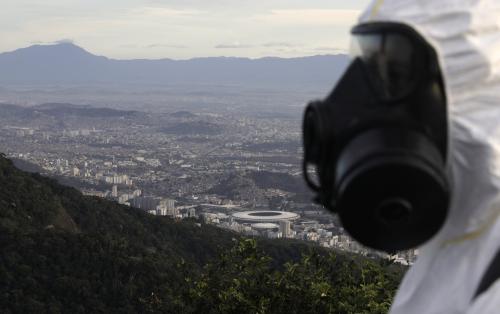 A Military member works on disinfection of the Christ the Redeemer statue, with the Maracana stadium in background ahead of its re-opening amid the coronavirus disease (COVID-19) outbreak, in Rio de Janeiro, Brazil, August 13, 2020. REUTERS/Ricardo Moraes